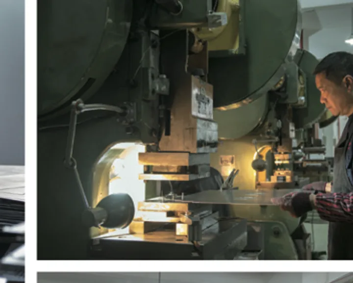 Worker at a CNC punching machine forming rack components
