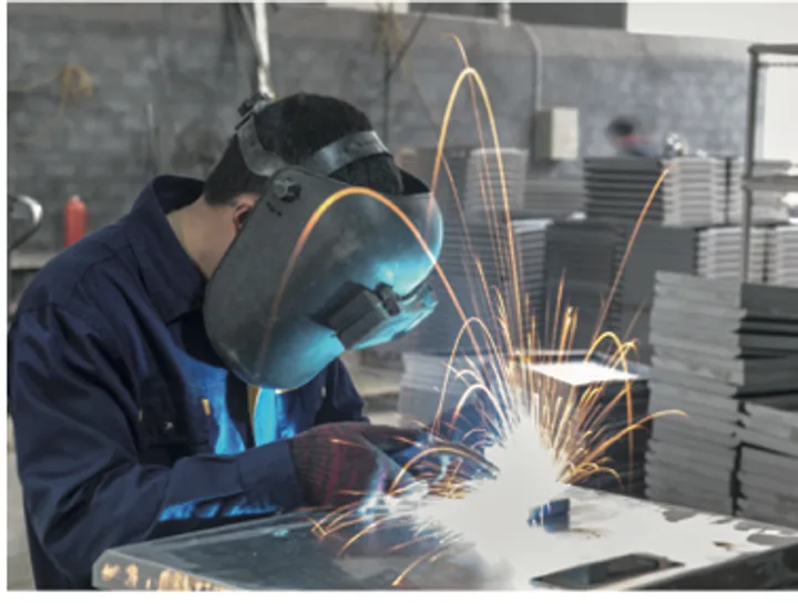 Welder joining a rack frame, sparks visible